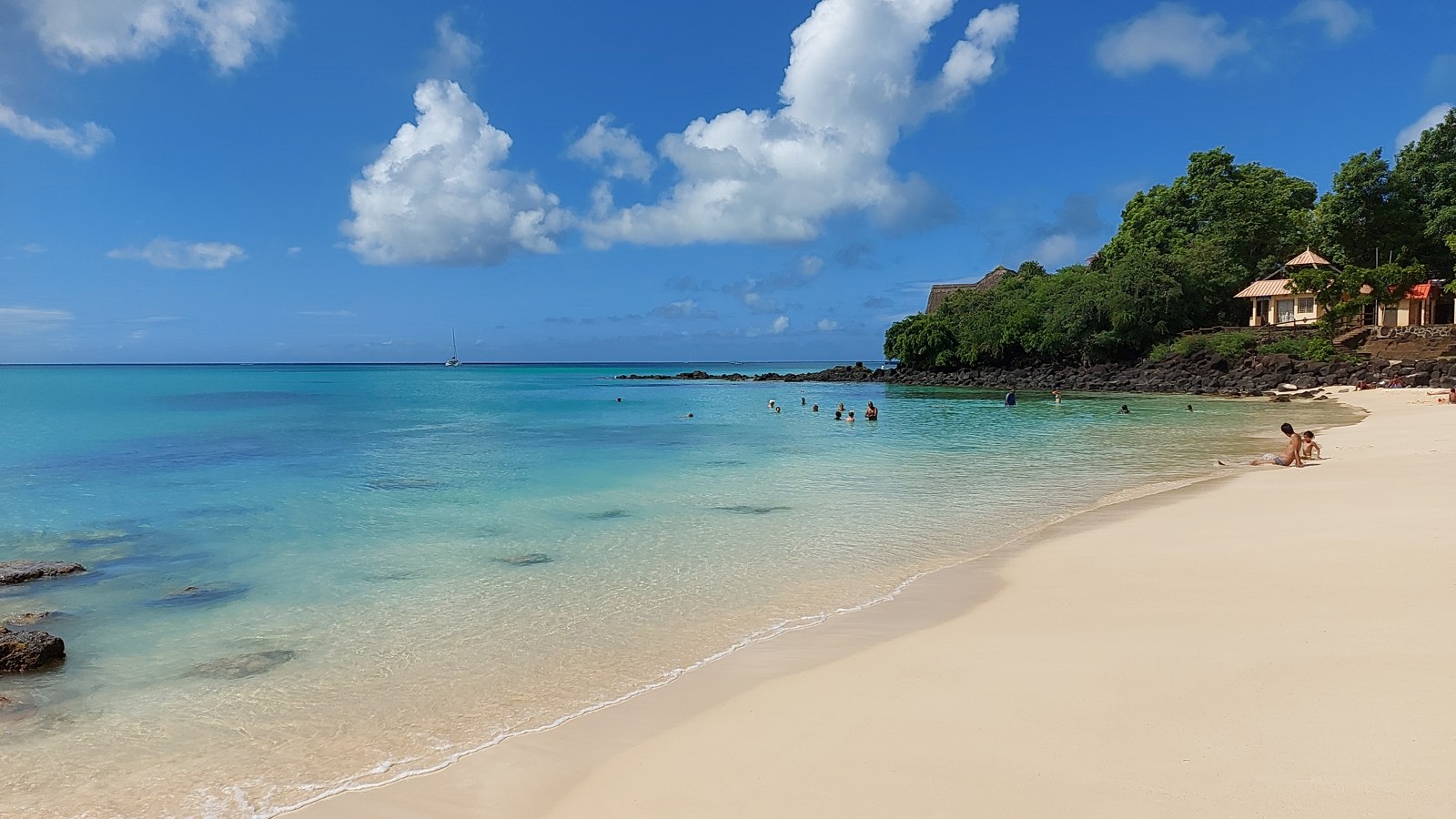 Pale sand and turquoise water at La Cuvette beach in Grand Baie